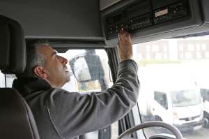 Conductor profesional activando su tacógrafo antes del comienzo de la jornada laboral